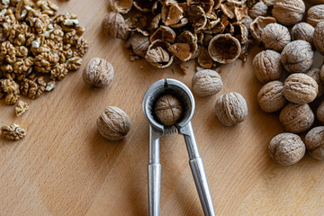 walnuts and nutcracker on wooden background