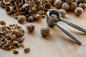 walnuts and nutcracker on wooden background