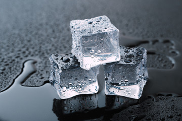 Pyramid of beautiful thawed ice cubes with drops of water