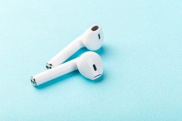  wireless bluetooth headphones lie on a blue background