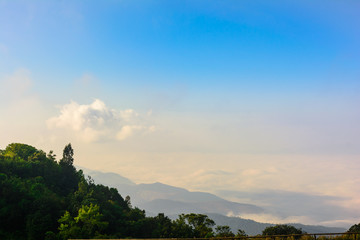 Nature landscape cloudy sky with mountain view and white fog in morning time at Thailand. Nature park and outdoor background