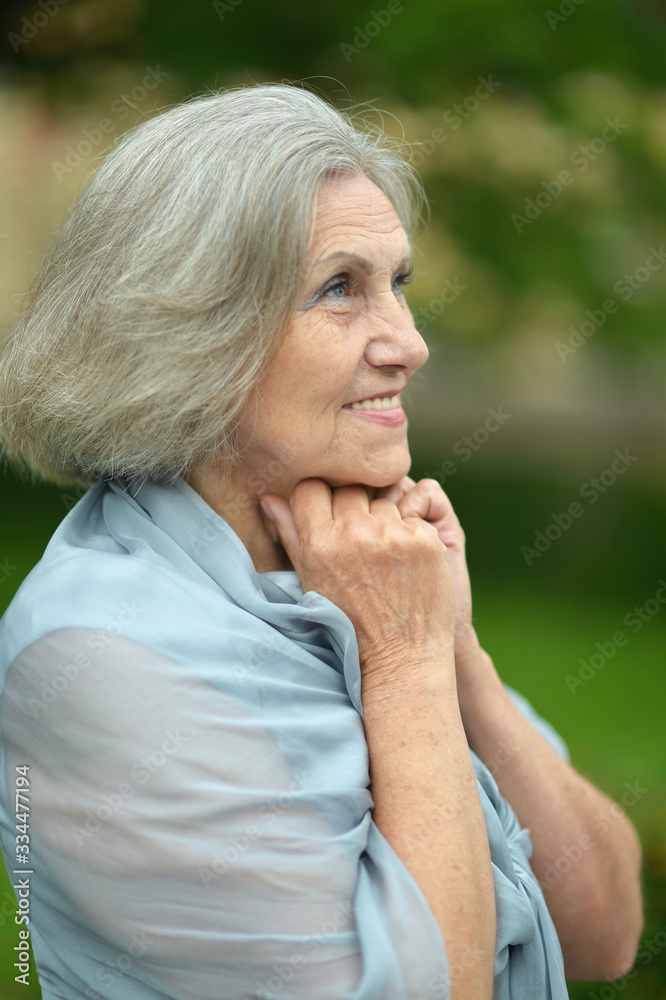 Sticker portrait of senior smiling woman in park