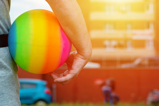 woman's hands in shape of heart holding globe with LGBT rainbow ribbon, lesbian, gay couple and love concept, LGBT marriage
