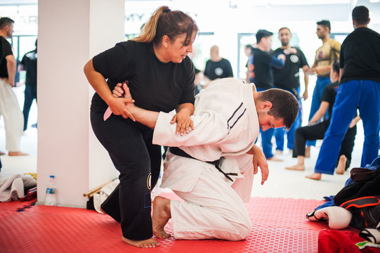 Female kapap student train knife disarm on woman self-defense seminar