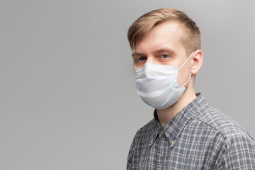 Man in a medical mask close up portrait. Healthcare. Covid-19 coronavirus symptoms