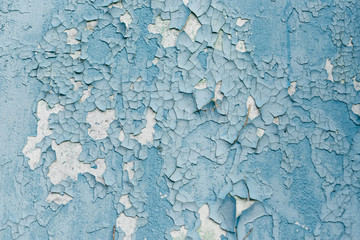 Cracked wall with old layers of paint in abandoned house