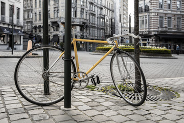 Fototapeta na wymiar Vintage Racebike locked at metal pole in urban environment