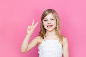 Baby, Little Girl on Pink Background Shows 2 Fingers