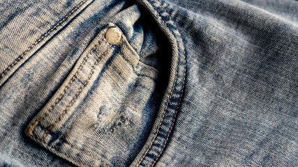 Pocket on blue jeans close-up. Textile material texture / macro denim background