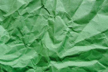 Crumpled green paper, empty abstract background, copy space.