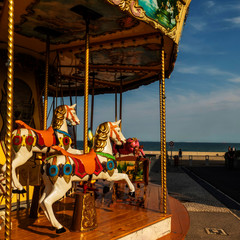 Carousel with two horses on a hot summer day in Wissant, France