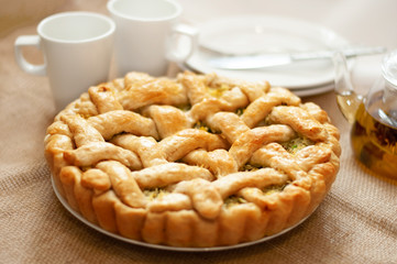 large cabbage or Apple pie on a light background and linen sacking. Rustic style