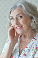 Portrait of beautiful happy senior woman at home
