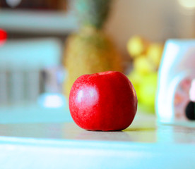  Red apple and diverse fruits on a table in a modern kitchen. Useful Conception of proper nutrition
