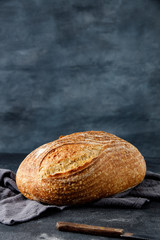 Traditional wheat freshly rustic baked bread on napkin. Artisan sourdough bread. Loaf of bread