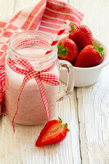 strawberry milkshake on wooden background