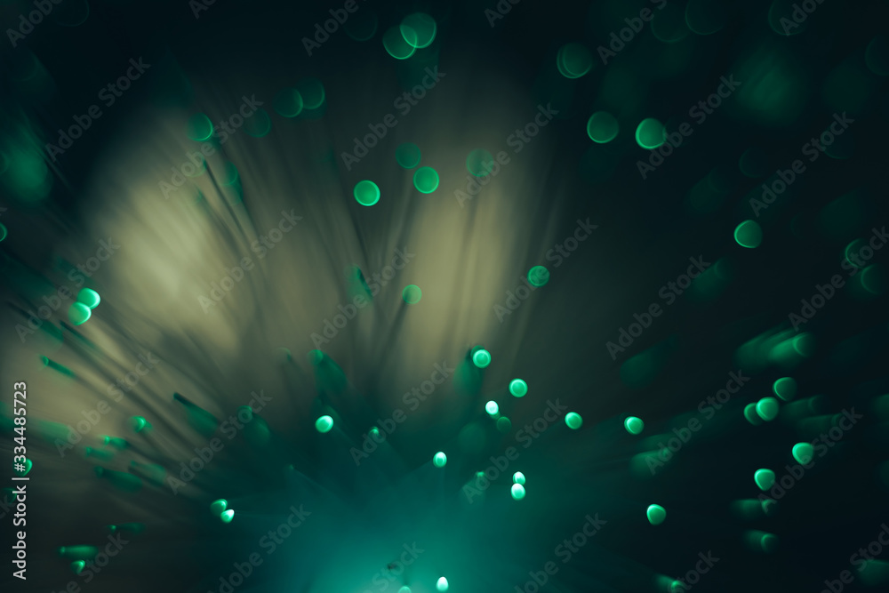 Poster Beautiful abstract green bokeh collapse background on a dark.