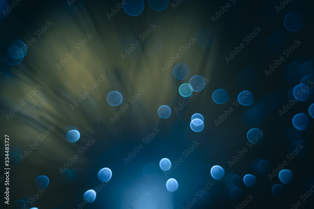 Poster beautiful abstract blue bokeh collapse background on a dark.
