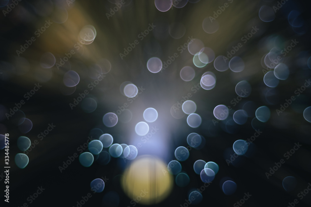 Poster beautiful abstract blue bokeh collapse background on a dark.