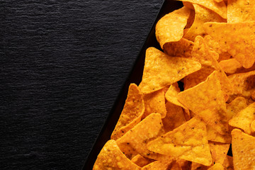 Delicious tortilla chips with black copy space - close up