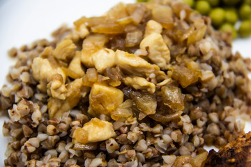 Delicious buckwheat porridge with chicken meat.Healthy and tasty diet food with chicken meat and green peas