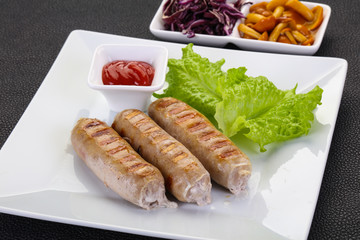 Grilled sausages served mushrooms and cabbage