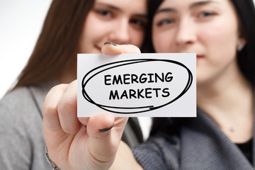 Business, technology, internet and network concept. Young businessman shows a keyword: Emerging...