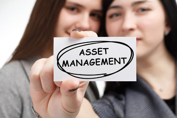 Business, technology, internet and network concept. Young businessman shows a keyword: Asset...