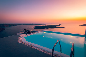Infinity pool on the rooftop at sunset in Santorini Island, Greece. Beautiful poolside and sunset...