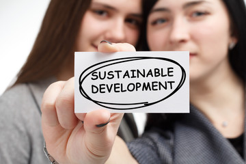 Business, technology, internet and network concept. Young businessman shows a keyword: Sustainable...