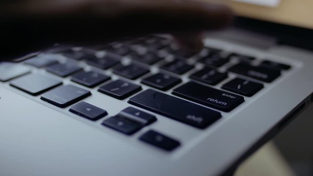 Enter button hit on laptop keyboard. Finishing project and sending email. Shot in 4k!