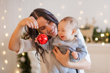 young mother and little son christmas toys