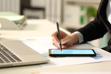 Executive hands filling document on phone