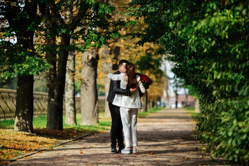 Fototapeta premium couple in love at sunset, gives a bouquet of flowers