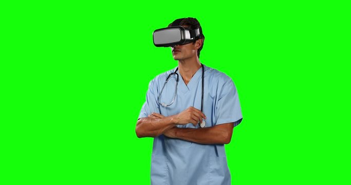 Front view of doctor using virtual reality touching screen with green screen