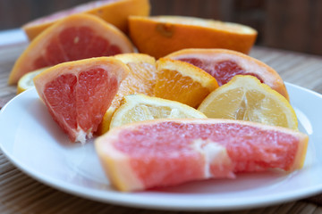 orange and grapefruit slices on a white surface vitamins in isolation, quarantine