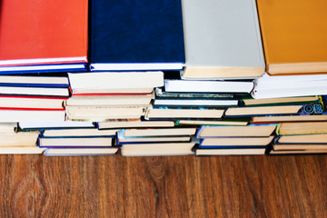 stack of old book on wooden table, education concept background, many books piles with copy space for text.