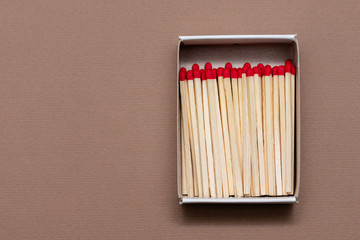 matches in a cardboard box on a craft color background