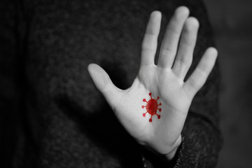 Coronavirus on dirty hands. Virus transfer on the hand of unwashed hands. Black and white photo red virus.