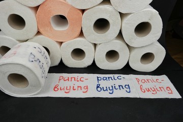 Rolls of white toilet paper with the text 