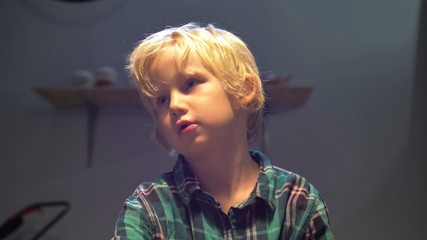 Boy talks to woman while sculpting in the workshop
