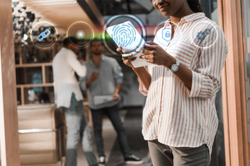 cropped view of african american businesswoman using digital tablet near multicultural colleagues, fingerprint illustration