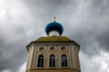 Russian Christian church, a temple on a background of gray sky and clouds.
