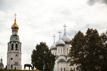 Fototapeta na wymiar Russian Christian church, a temple on a background of gray sky and clouds.