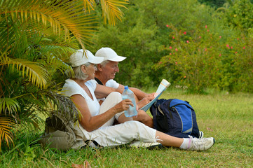 Portrait of elderly couple of tourists with map