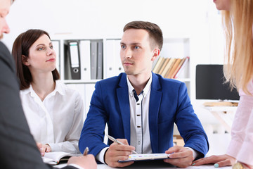 Group of people sit in office deliberate on problem portrait. White collar talk and listen idea discuss profit review sale market debate train lawyer document study finance adviser job concept