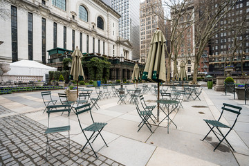Fototapeta na wymiar empty chairs and tables in deserted Bryant Park during coronavirus pandemic city lockdown