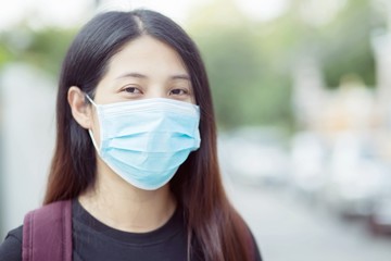 Women wearing masks to protect against germs, the virus, Covid 19 and batteries.