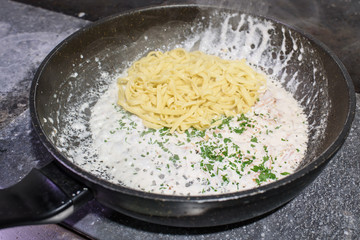 The process of making carbonara pasta for restaurant guests. Tasty food.