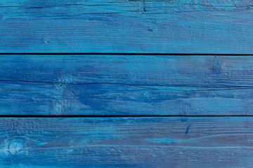 Old blue wooden background with cracks and stripes